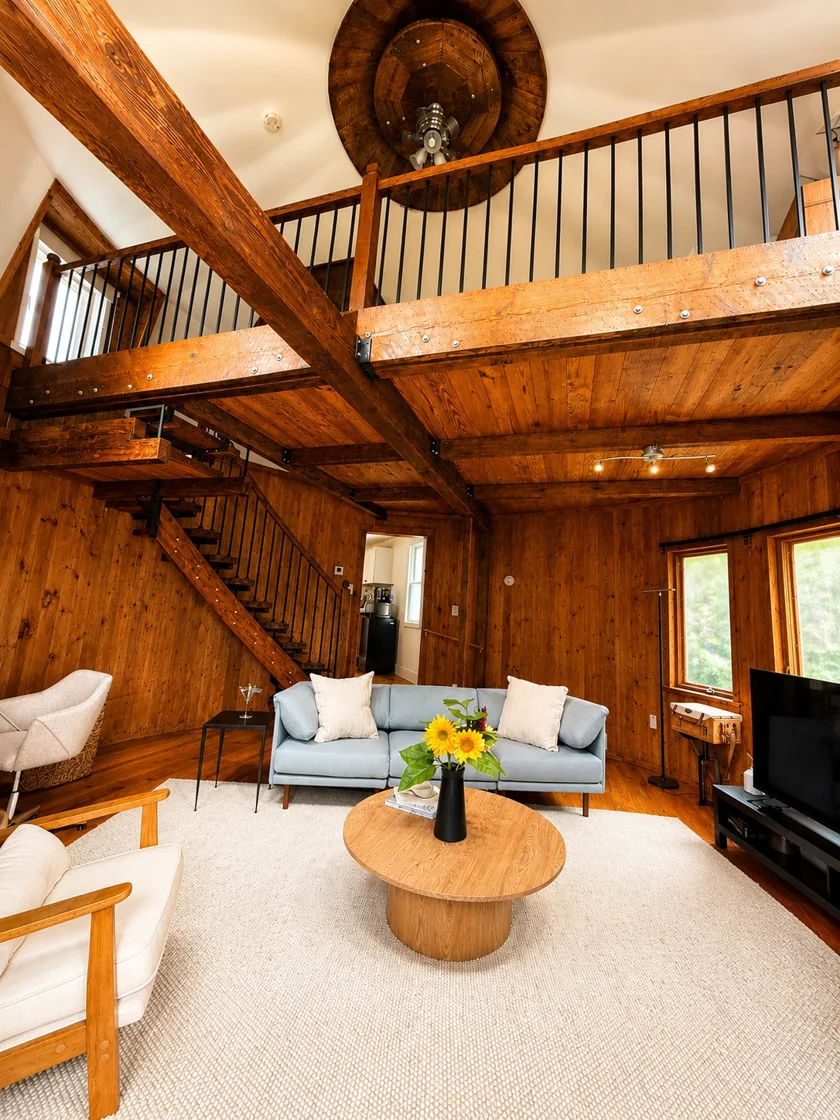 Living area at The Silo, with a wooden staircase leading to the open loft.